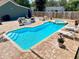 Backyard pool and spa surrounded by lounge chairs and an umbrella at 425 E Orange St, Tarpon Springs, FL 34689