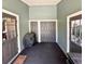 Enclosed porch featuring side doors, a grill, and storage closets at 425 E Orange St, Tarpon Springs, FL 34689