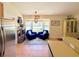 Open kitchen features a sitting area with two blue chairs, accent rug, and plenty of natural light from a window at 425 E Orange St, Tarpon Springs, FL 34689