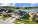 Beautiful aerial view of home, lush landscaping, three car garage and picturesque lake at 4354 Barletta Ct, Wesley Chapel, FL 33543