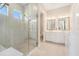 Elegant bathroom with a glass enclosed shower and double vanity at 4354 Barletta Ct, Wesley Chapel, FL 33543
