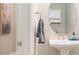 Stylish half-bathroom with a pedestal sink, oval mirror, and neutral decor at 4354 Barletta Ct, Wesley Chapel, FL 33543