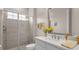Bright bathroom with white vanity, light countertops, and a glass enclosed shower at 4354 Barletta Ct, Wesley Chapel, FL 33543