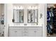 Bright bathroom with dual sinks, vanity, and mirrors at 4354 Barletta Ct, Wesley Chapel, FL 33543