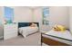 Spacious bedroom featuring two beds, two windows, and bright walls at 4354 Barletta Ct, Wesley Chapel, FL 33543