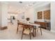 Open dining area featuring an oval table, modern art, and sleek lighting at 4354 Barletta Ct, Wesley Chapel, FL 33543