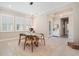 Elegant dining room with light floors, neutral walls, modern lighting, and three bright windows at 4354 Barletta Ct, Wesley Chapel, FL 33543