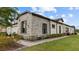 Stunning home exterior showcasing stone details, professionally landscaped grounds, and neutral colors at 4354 Barletta Ct, Wesley Chapel, FL 33543