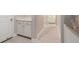 Bright hallway with white cabinets, light floors, and white trim throughout at 4354 Barletta Ct, Wesley Chapel, FL 33543