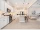 Bright, open kitchen features white cabinets, stainless steel appliances, and island seating at 4354 Barletta Ct, Wesley Chapel, FL 33543