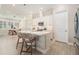 Kitchen island with white countertop, pendant lights, and seating at 4354 Barletta Ct, Wesley Chapel, FL 33543