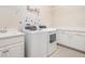 Functional laundry room with a sink, washer, dryer, and cabinet space at 4354 Barletta Ct, Wesley Chapel, FL 33543