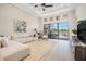 Bright and airy living room with a view of the outdoor patio and lush greenery at 4354 Barletta Ct, Wesley Chapel, FL 33543