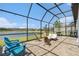 Serene screened-in patio with beautiful lake views and comfortable seating at 4354 Barletta Ct, Wesley Chapel, FL 33543