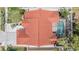 An aerial shot shows the roof and pool of the house surrounded by landscaped grounds and neighboring homes at 4847 Harbor Woods Dr, Palm Harbor, FL 34683