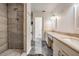 Bathroom with walk-in shower, double sink vanity, and black marble-style floors at 4847 Harbor Woods Dr, Palm Harbor, FL 34683