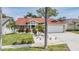 Charming single-Gathering home featuring a two-car garage and front yard landscaping at 4847 Harbor Woods Dr, Palm Harbor, FL 34683