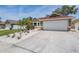 Well-maintained home with a two-car garage and a driveway at 4847 Harbor Woods Dr, Palm Harbor, FL 34683