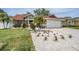 Inviting one-story home with a new roof, a two-car garage, and a well-manicured lawn with garden at 4847 Harbor Woods Dr, Palm Harbor, FL 34683