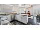 Open kitchen with breakfast bar, stainless steel appliances, granite countertops, and black marble-style flooring at 4847 Harbor Woods Dr, Palm Harbor, FL 34683