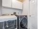 Laundry room with washer, dryer, and storage cabinets at 4847 Harbor Woods Dr, Palm Harbor, FL 34683