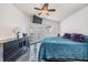 Main bedroom with TV, ceiling fan, doors to the backyard, and black marble-style flooring at 4847 Harbor Woods Dr, Palm Harbor, FL 34683