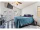 Main bedroom with ceiling fan, doors to the backyard, and black marble-style flooring at 4847 Harbor Woods Dr, Palm Harbor, FL 34683