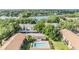 Aerial view of community featuring mature landscaping, a pool, and covered parking areas at 4917 Puritan Cir # 105, Tampa, FL 33617