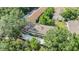 Aerial view of the property surrounded by lush greenery and mature trees at 4917 Puritan Cir # 105, Tampa, FL 33617