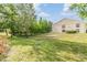 Expansive backyard with mature trees offering ample shade and privacy for outdoor activities at 4917 Puritan Cir # 105, Tampa, FL 33617