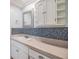 Charming bathroom with stylish wall tiles, white cabinetry, and a vanity mirror at 4917 Puritan Cir # 105, Tampa, FL 33617