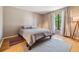 Minimalist bedroom featuring natural light, hardwood floors, and neutral décor at 4917 Puritan Cir # 105, Tampa, FL 33617