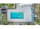 Aerial view of rectangular community pool, sunbathing lounge chairs and parking at 4917 Puritan Cir # 105, Tampa, FL 33617