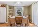 Warm dining area with rustic table, natural light, and convenient shelving at 4917 Puritan Cir # 105, Tampa, FL 33617