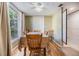 Cozy dining room with a ceiling fan, large window, and seating for six at 4917 Puritan Cir # 105, Tampa, FL 33617