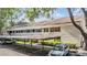 Inviting exterior shot of a condo building with covered parking and well-maintained landscaping at 4917 Puritan Cir # 105, Tampa, FL 33617