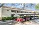 Well-maintained exterior of a condominium building with covered parking and manicured landscaping at 4917 Puritan Cir # 105, Tampa, FL 33617