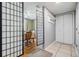 Bright hallway with access to dining room, closet and grey tile flooring at 4917 Puritan Cir # 105, Tampa, FL 33617