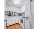 Bright kitchen with white cabinets, modern appliances, and a view into the living area at 4917 Puritan Cir # 105, Tampa, FL 33617