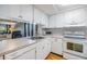 Well-lit kitchen with sleek appliances, white cabinetry, and a breakfast bar overlooking the living room at 4917 Puritan Cir # 105, Tampa, FL 33617