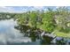 Scenic lakefront property featuring a private dock and lush greenery along the shoreline at 4917 Puritan Cir # 105, Tampa, FL 33617