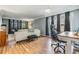 Bright living room featuring a comfortable sofa and large windows with natural light at 4917 Puritan Cir # 105, Tampa, FL 33617