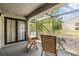 Screened patio with seating overlooking a lush green landscape and trees at 4917 Puritan Cir # 105, Tampa, FL 33617