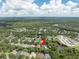 Neighborhood aerial view showing a home with backyard pool surrounded by lush greenery at 6116 Skylarkcrest Dr, Lithia, FL 33547