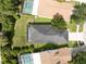 Aerial view of home highlighting the gray roof, screened in lanai, spacious yard, and surrounding trees at 6116 Skylarkcrest Dr, Lithia, FL 33547