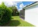 Lush backyard featuring the home's screened in lanai with outdoor seating at 6116 Skylarkcrest Dr, Lithia, FL 33547