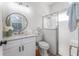 Modern bathroom featuring a new vanity, round mirror, and glass-enclosed shower for a luxurious bathing experience at 6116 Skylarkcrest Dr, Lithia, FL 33547