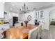 An open-concept design showing the kitchen and dining room with stainless steel appliances and an inviting dining table at 6116 Skylarkcrest Dr, Lithia, FL 33547