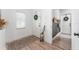 Bright entryway featuring white walls, wood floors, window, coat racks, a decorative umbrella stand and rug at 6116 Skylarkcrest Dr, Lithia, FL 33547