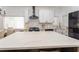 Spacious kitchen featuring white cabinetry, a white quartz countertop, stainless steel appliances, and a center island with barstool seating at 6116 Skylarkcrest Dr, Lithia, FL 33547